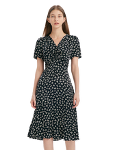 a lady in a black floral printed v-neck twisted midi dress